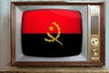 Old tube vintage TV with the national flag of Angola on the screen, the concept of eternal values Ã¢â¬â¹Ã¢â¬â¹on television, global